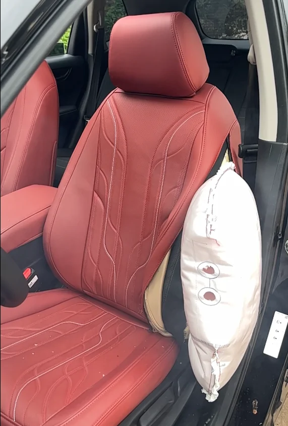 EKR red seat cover photographed with a deployed seat mounted side airbag